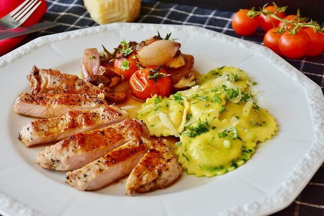 Mind blowing healthy low fat dishes neatly arranged one white clay plate and red tomoto can be seen near by